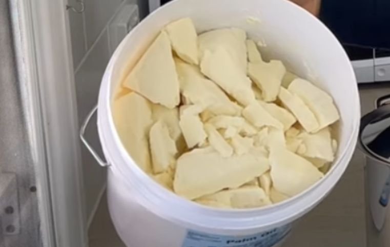 A bucket of semi-solid palm oil for soap making